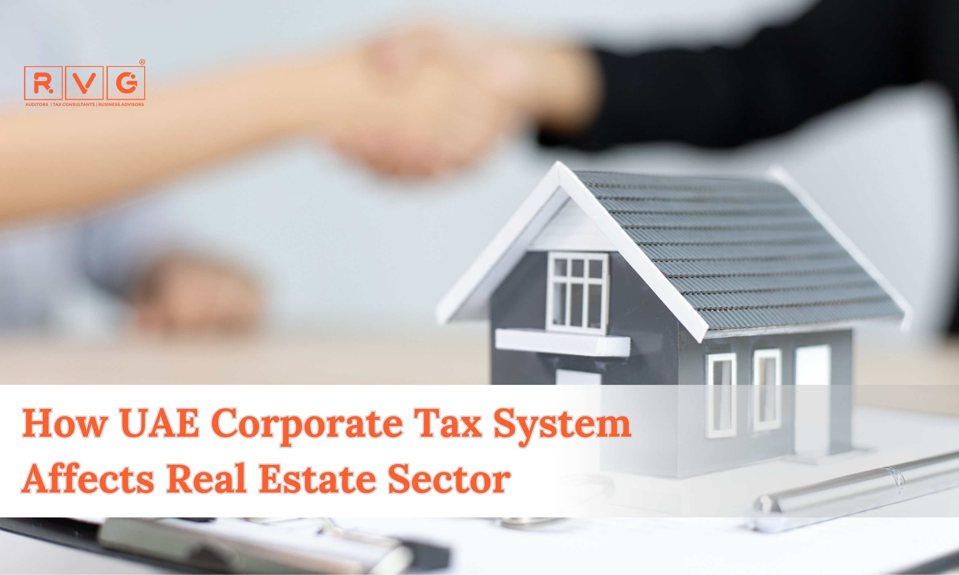 Model house with a handshake in the background, symbolizing UAE real estate and corporate tax impact.