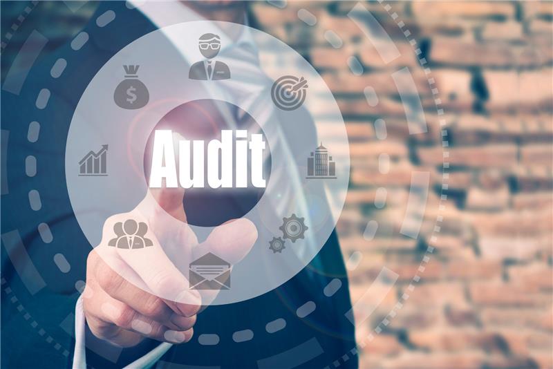 Businessman pointing to the word 'Audit' representing stock audit services in Dubai.