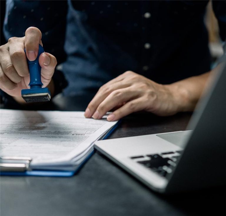 Professional verifying documents for NRI Taxation Services in Dubai